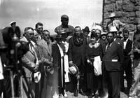 [Solemn line of Men, Women, & Children in front of bust of Will Rogers]