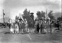 [Six Indians standing, three on either side of Leo Cremer mounted on horse]