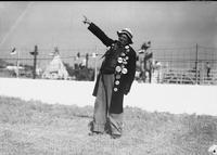 [Unidentified rodeo clown wearing long coat with pin buttons]