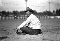 [Unidentified rotund cowboy sitting on ground]