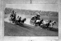[pair of stagecoaches rounding corner of track]