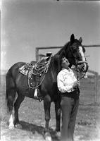 [Unidentified cowgirl beside horse]