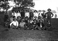 [Group of Unidentified Cowboys and Cowgirls in front of trees]