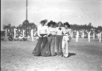 [Four posed unidentified cowgirls]