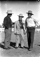 [Leo Cremer standing to the right of two unidentified western-attired men]