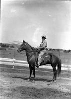 [Unidentified Man in business suit on horseback with four-rein Pelham bit]