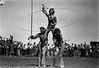 [Ramsey Sisters with two standing on ground each spinning a rope supporting the third]
