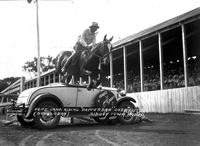 Pete Carr Riding "Dapper Dan" Over Auto, Sidney Iowa Rodeo