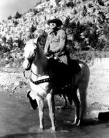 [Possibly Tex Ritter in pr shot in fringed buckskins on horse]