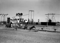 [Unidentified calf roper running toward calf]