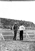 [Cremer and one unidentified man with cigar in arena]