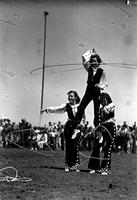 [Ramsey Sisters with two standing on ground each spinning a rope supporting the third]