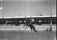 [Unidentified Cowboy riding and staying with rearing bronc]