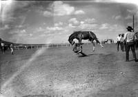 [Unidentified Cowboy landing left foot to ground as Bronc goes airborne]