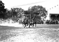 [Unidentified cowboy preparing to wrestle steer]