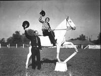 [Vaughn Krieg mounted on horse with unidentified cowboy standing beside]