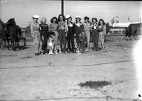 [Group of nine unidentified cowgirls and two girls]