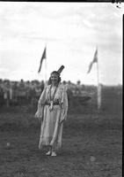 [Possibly Josephine Proctor wearing Indian buckskin dress, single feather on head and moccasins]