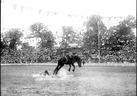 [Unidentified Cowboy into the dirt & dust after leaving rear of charging Saddle Bronc]