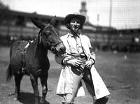 [Possibly Jack Owens, rodeo clown, posed with mule, possibly Jack]