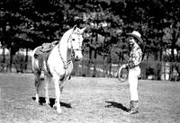 [Possibly Junior Eskew in flowered shirt holding rope, horse with silver mounted tack]