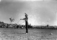 [Unidentified young Cowgirl spinning a small rope loop while encircling herself with another]