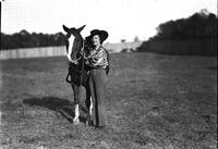 [Possibly Josephine Proctor posed beside horse]