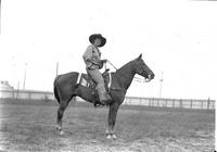 [Possibly Grace White posed atop horse]