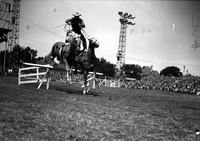 [Possibly Cecil Cornish doing Roman Stand jump over hurdles]