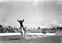 [Possibly Vaughn Krieg doing Hippodrome Stand with arms raised above head forming a wreath]