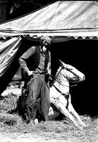 [Unidentified Rodeo clown and mule in front of tent]