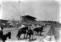 [End of grand entry looking toward grandstand; front of entry having looped back around]