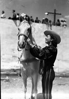 [Polly Mills in profile beside horse at the Tulsa Stampede]