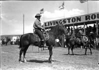 [Unidentified bespectacled cowboy on horseback at Livingston Roundup]