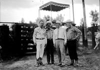 [Autry and three unidentified men in front of scalloped canopy]