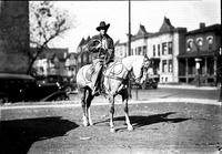 [Unidentified Cowboy on stationary horse holding rope loop in both hands]