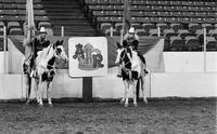 Cowgirls on horseback with Flags