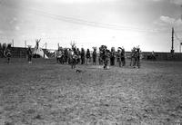 [Group of Indian men dancing in middle of arena]