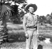 [Possibly Jack Rinehart standing near a palmetto tree]