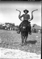[Unidentified cowboy posed atop Bobby the Steer]