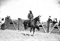 [Leo Cremer on horseback, corona saddle pad, tapederos and silver trim chutes in background]