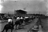 [End of grand entry looking toward grandstand; front of entry having looped back around]