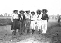 [Six cowgirls posed in a line]
