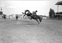 [Unidentified Cowboy leaving side of bronc feet first]