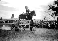 [Possibly one of the younger Graham sisters on a pony jumping hurdle]