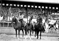 [Cremer and two unidentified cowboys on horseback in arena]