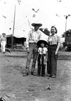 [Gene Autry standing with unidentified little boy and woman]