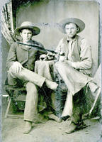Two cowboys drinking whiskey