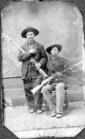 Two hunters posing with firearms