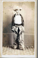 Cowboy (possibly Hispanic) with whip and wearing wooly chaps